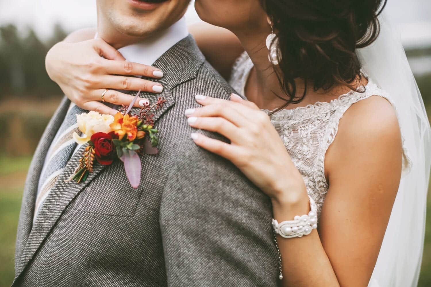 Stylish couple on their autumn wedding day and their accessories: boutonniere, bracelet Stylish couple on their autumn wedding day and their accessories: boutonniere, bracelet